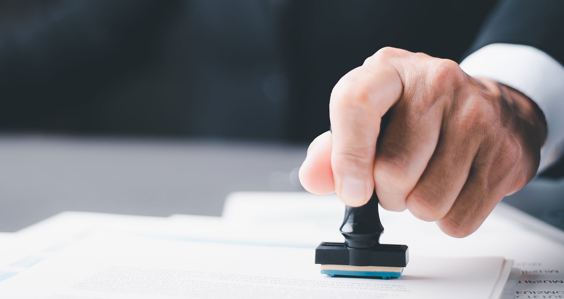 person stamping a document