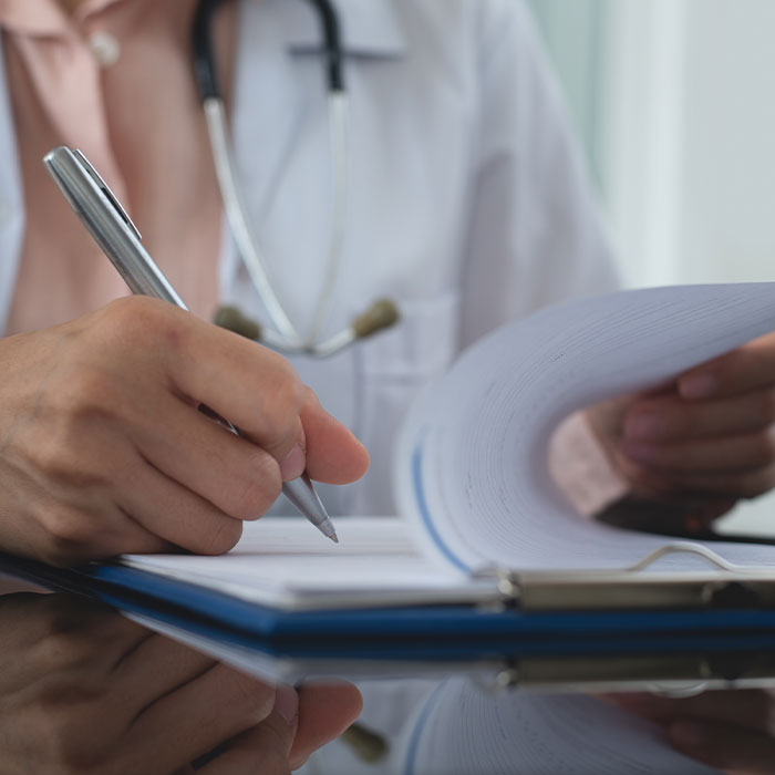 doctor filling out paperwork